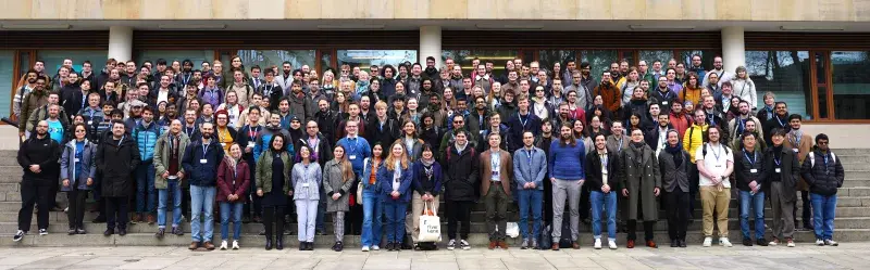 A large group of people on staircase in front of a building